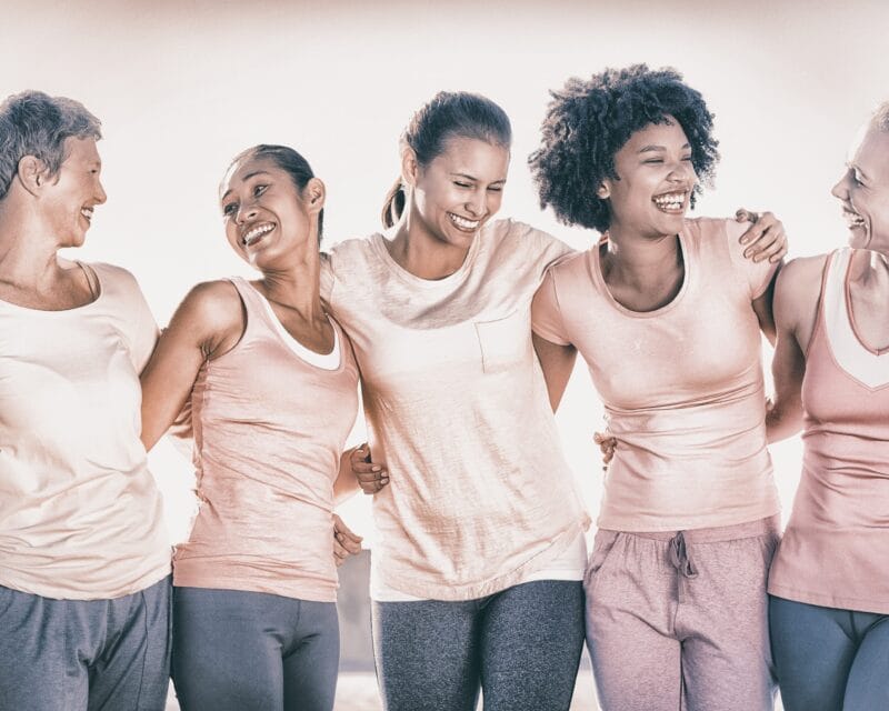 Five women with arms around each other